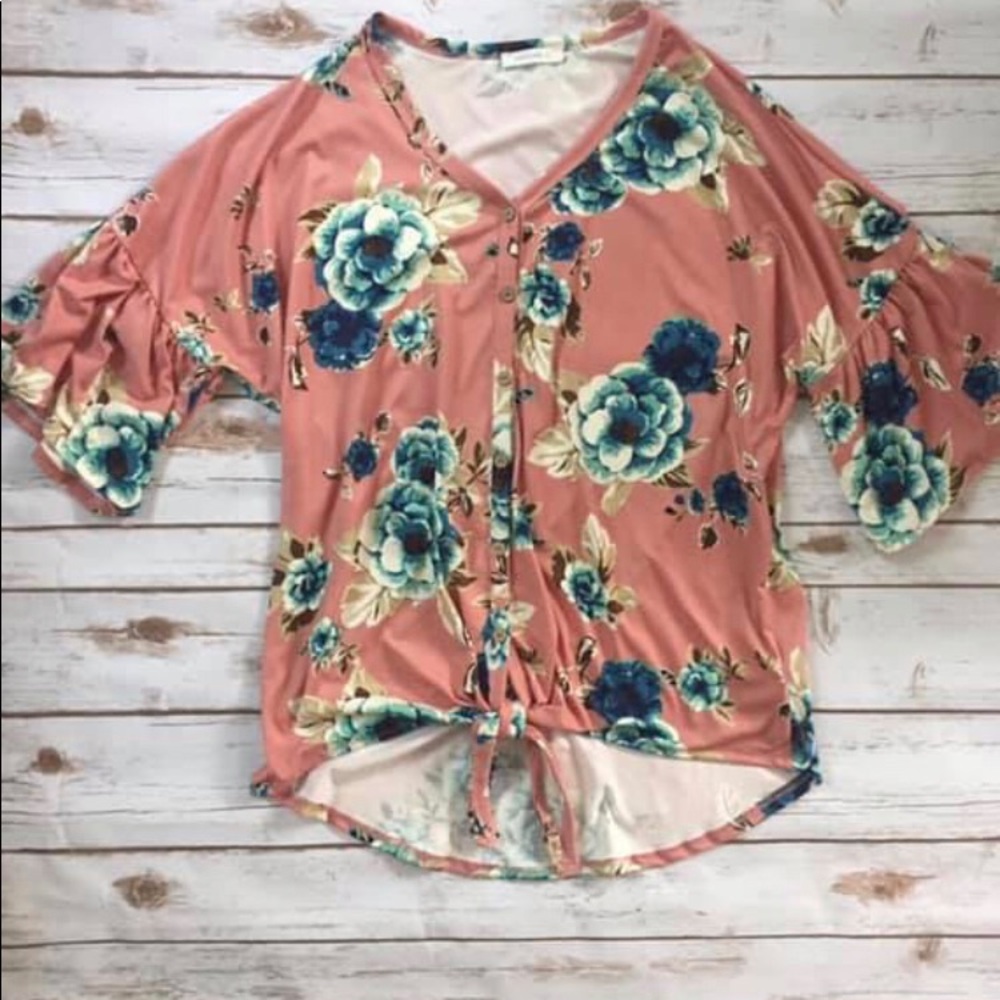 Mauve floral top with ruffles at sleeves.